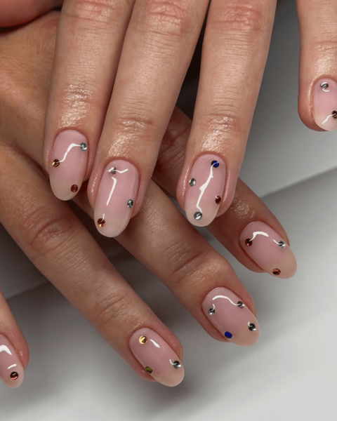 gem nails colorful rhinestones on nude base nail polish